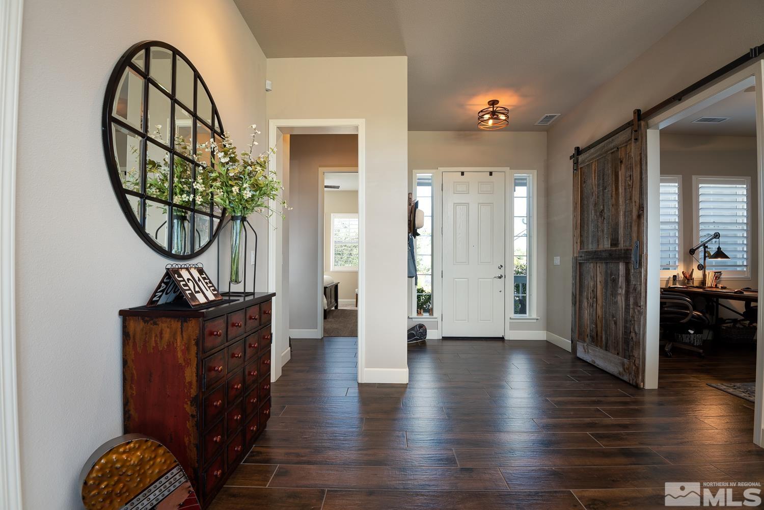 Undisclosed Address Minden, NV 89423 - Photo 7 of 33 a view of a hallway to a livingroom and a dinning room with furniture