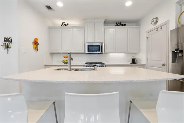 a kitchen with stainless steel appliances a refrigerator sink and cabinets
