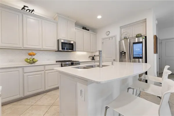 a kitchen with a stove and a refrigerator