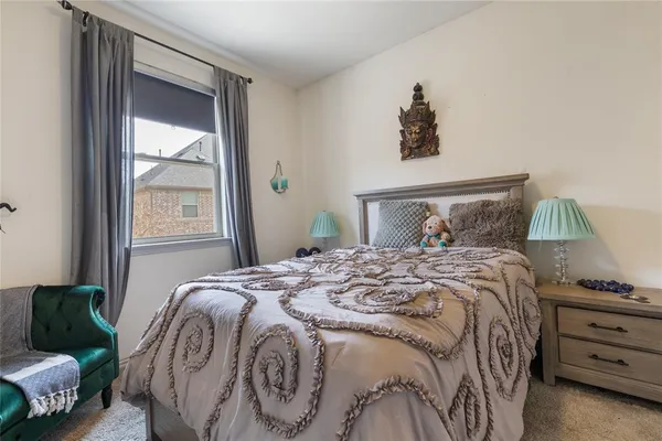 a bedroom with a bed and a night stand