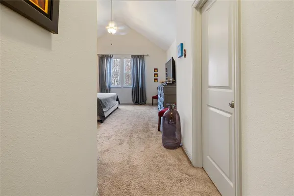 a large bed sitting in a bedroom next to a window