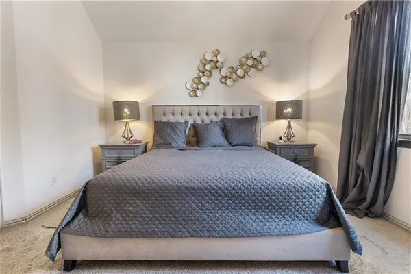 a bedroom with a bed and cabinet