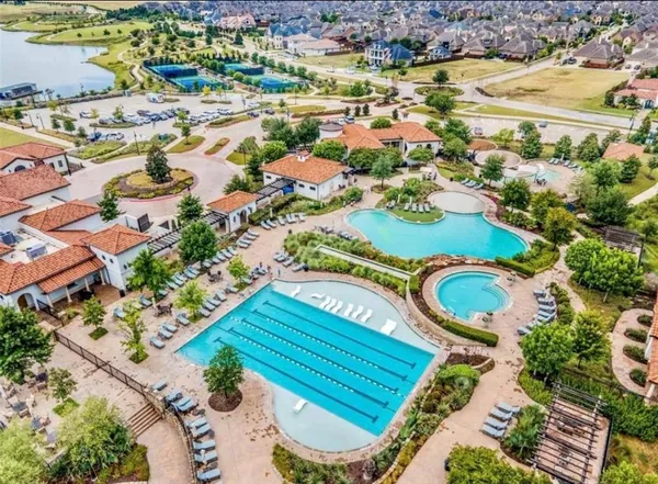 an aerial view of multiple houses with yard