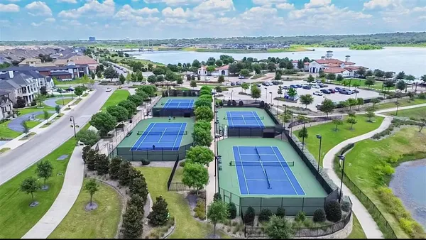an outdoor space with lots of plants and lake view