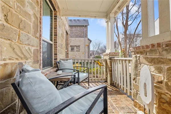 a view of a balcony that has two chairs and a table