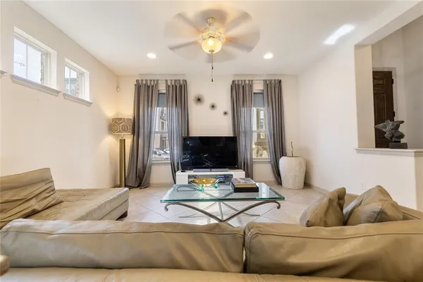 a living room with furniture and a chandelier