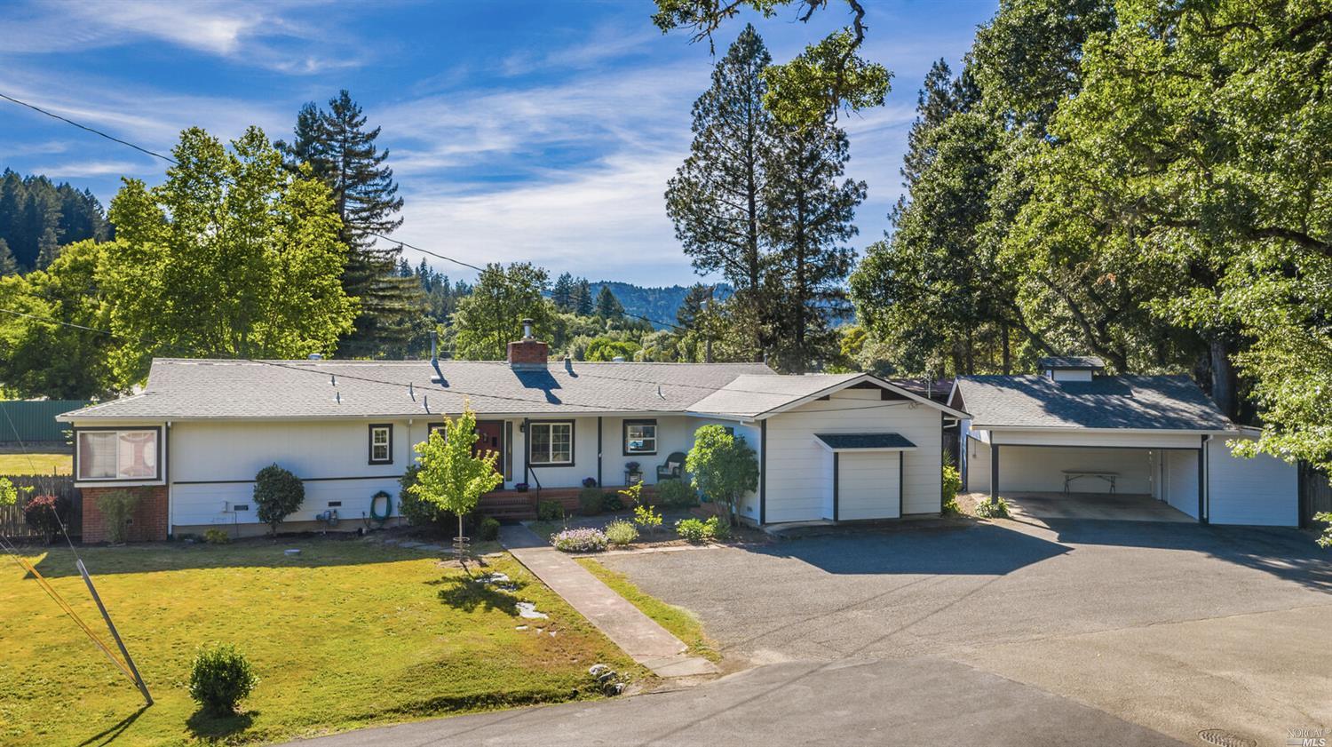 10 Maple Street Willits, CA 95490 - Photo 1 of 1 a view of a white house with swimming pool lawn chairs and a fire pit
