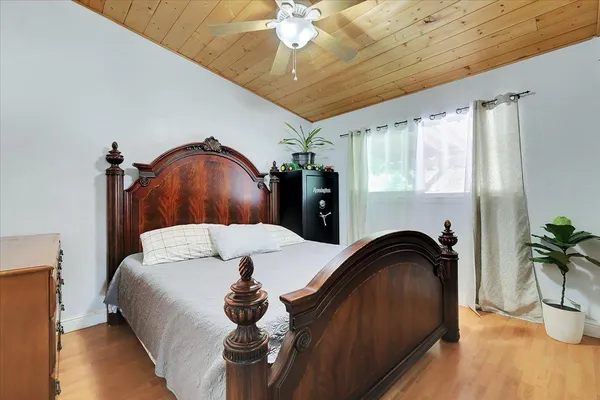 a bedroom with a bed and a potted plant