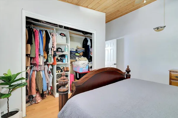 a bedroom with a bed and a dresser