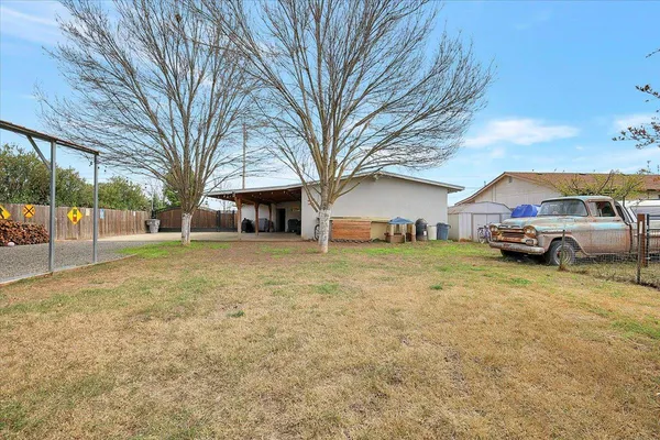 a view of a house with a yard and furniture