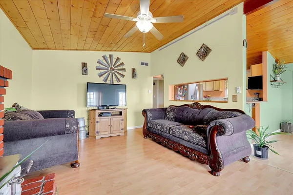 a living room with furniture a clock and a fireplace