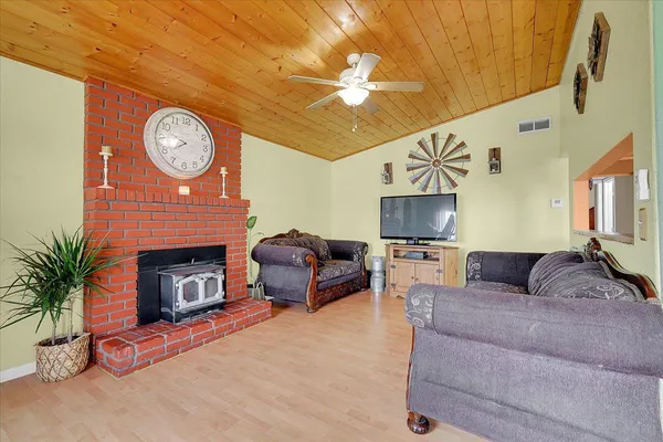 a view of a dining room with furniture and chandelier