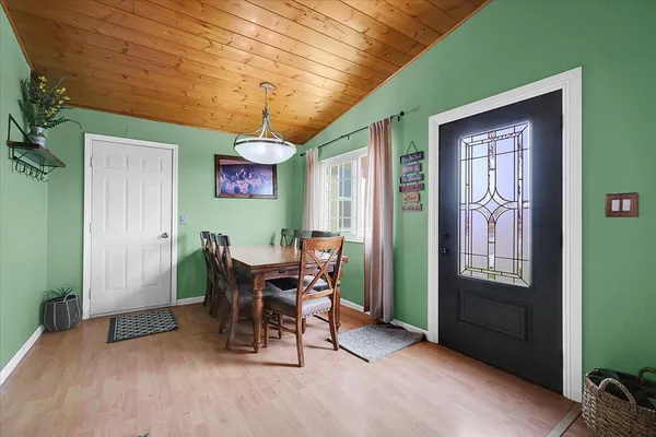 a view of a dining room with furniture and a chandelier