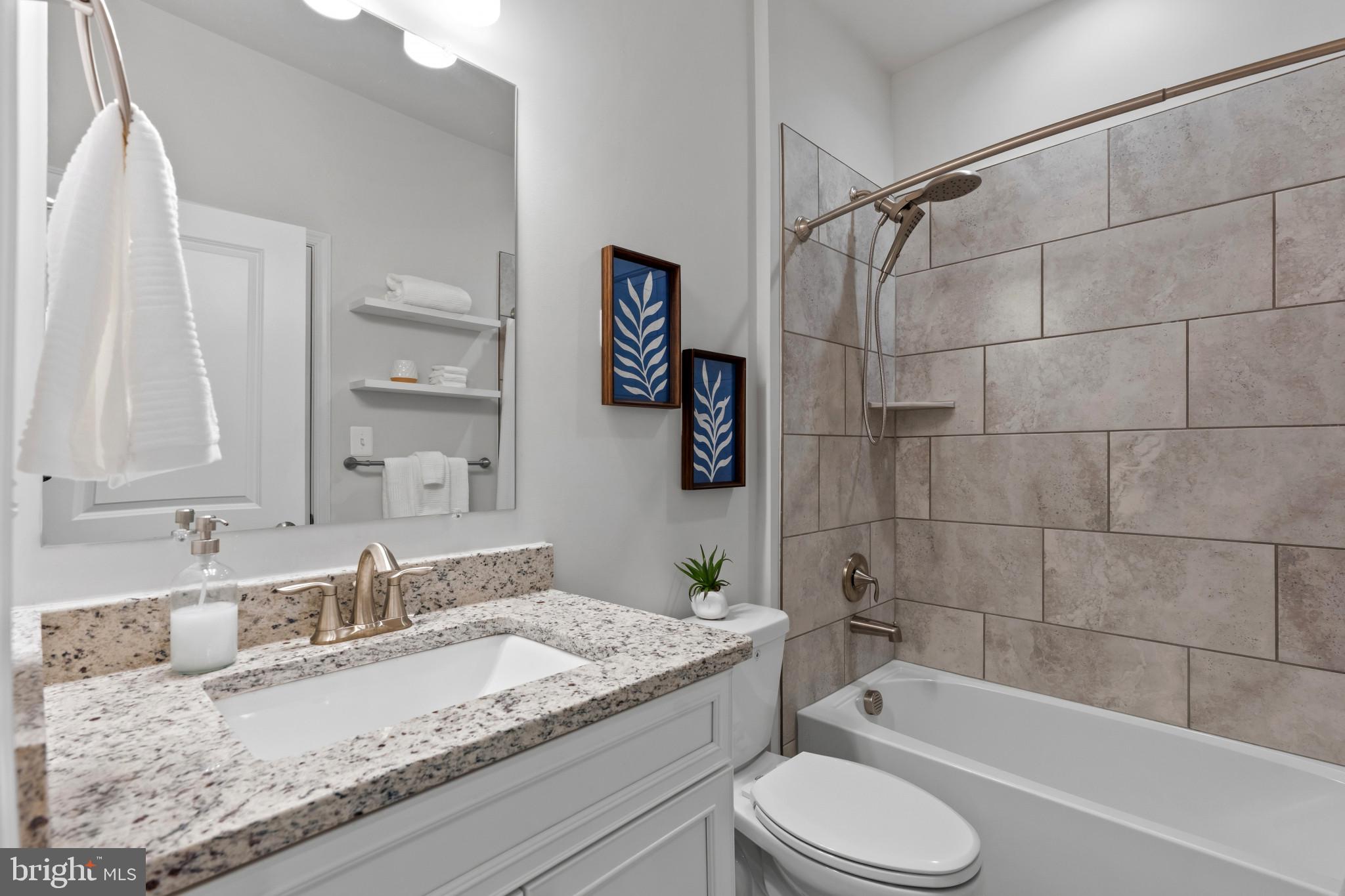 703 Perception Way Aberdeen, MD 21001 - Photo 11 of 42 a bathroom with a granite countertop sink toilet and shower