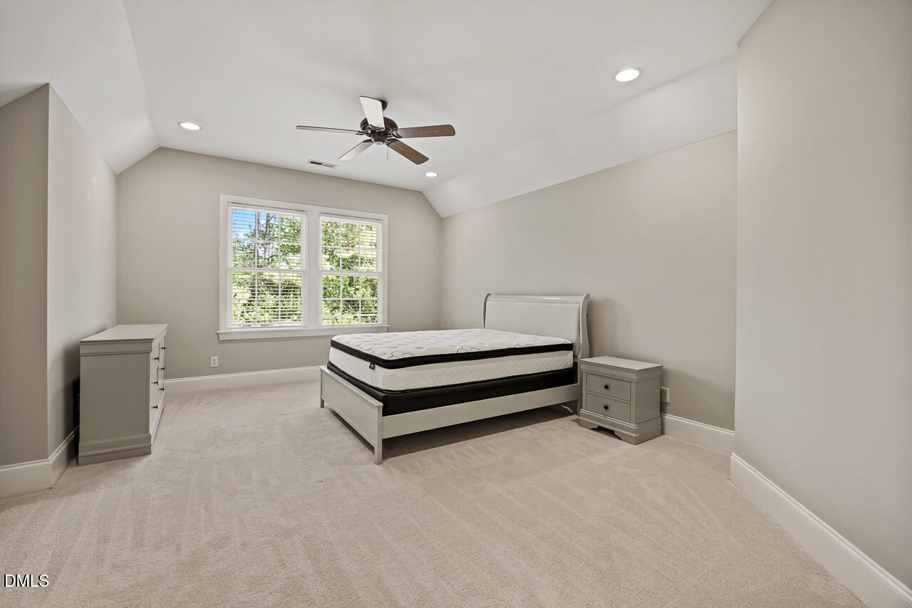 4004 Frontenac Court Apex, NC 27539 - Photo 38 of 61 a spacious bedroom with a bed and a window