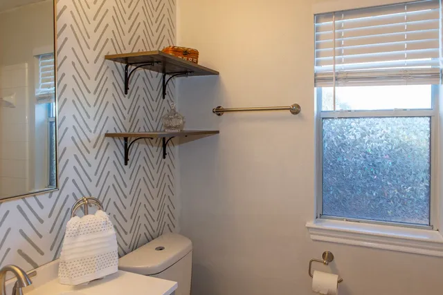a bathroom with a shower curtain and a window