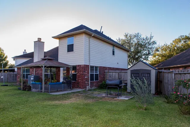 a view of a house with a yard and furniture