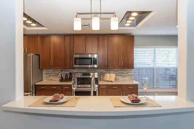 a kitchen with a stove a microwave and wooden cabinets