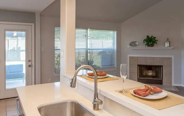a kitchen with a sink and a fireplace