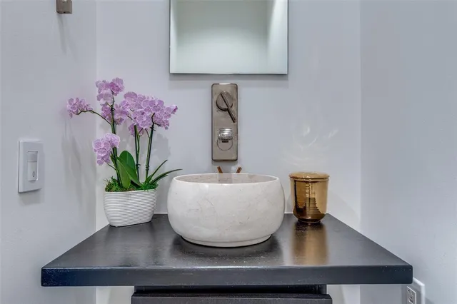 a bathroom with a tub sink and mirror