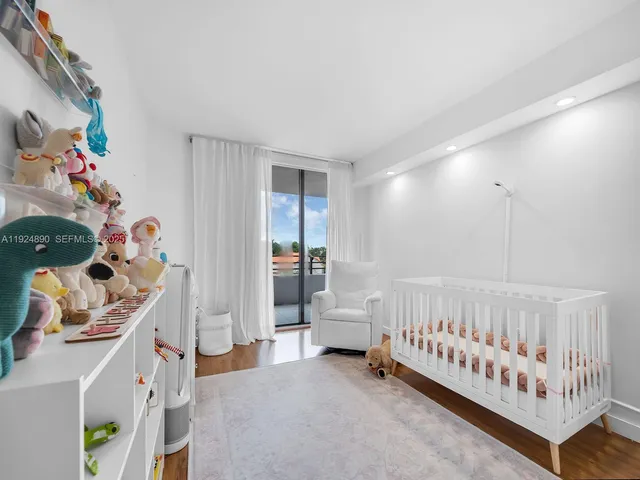 a bedroom with furniture and baby crib