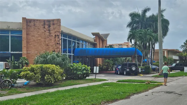 a view of a patio with table and chairs potted plants and palm tree