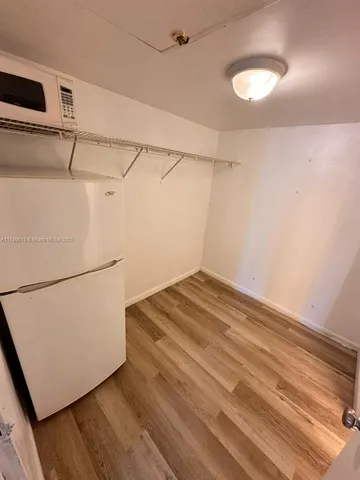 a view of a room with wooden floor
