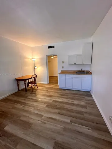a living room with kitchen island granite countertop furniture and a fireplace
