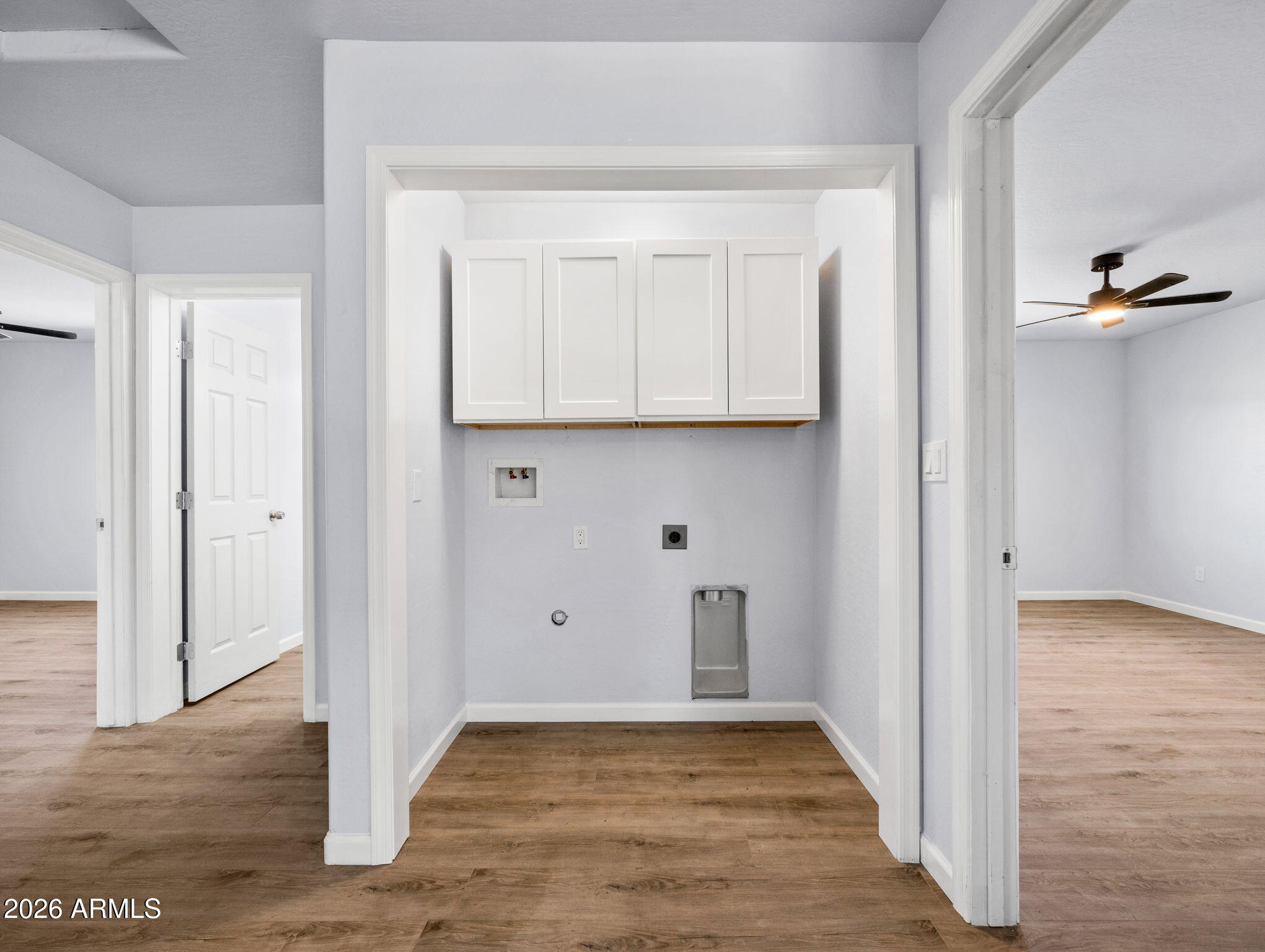 18278 Frontier Road Peeples Valley, AZ 86332 - Photo 27 of 31 a view of an empty room with wooden floor and a bathroom