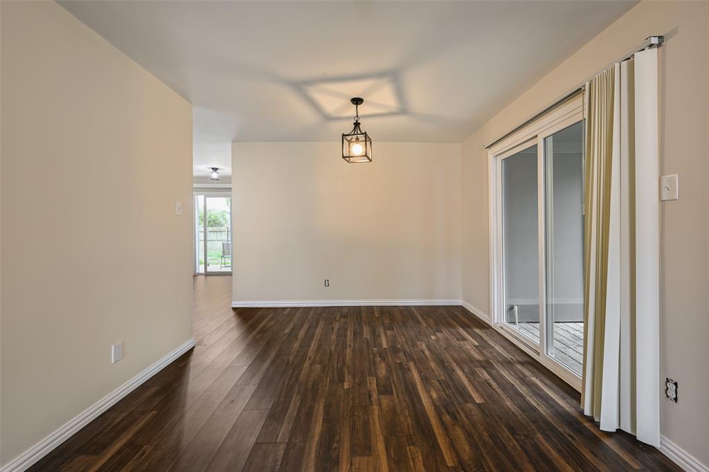 7318 Emory Oak Lane Dallas, TX 75249 - Photo 19 of 28 Spacious room featuring wood-finish flooring, light-toned walls, and a contemporary ceiling fixture