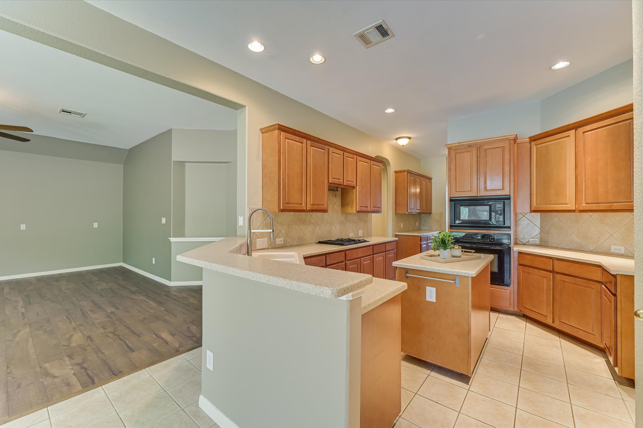 8024 Cobblestone Austin, TX 78735 - Photo 14 of 27 a kitchen with stainless steel appliances granite countertop a stove a sink a refrigerator and a oven