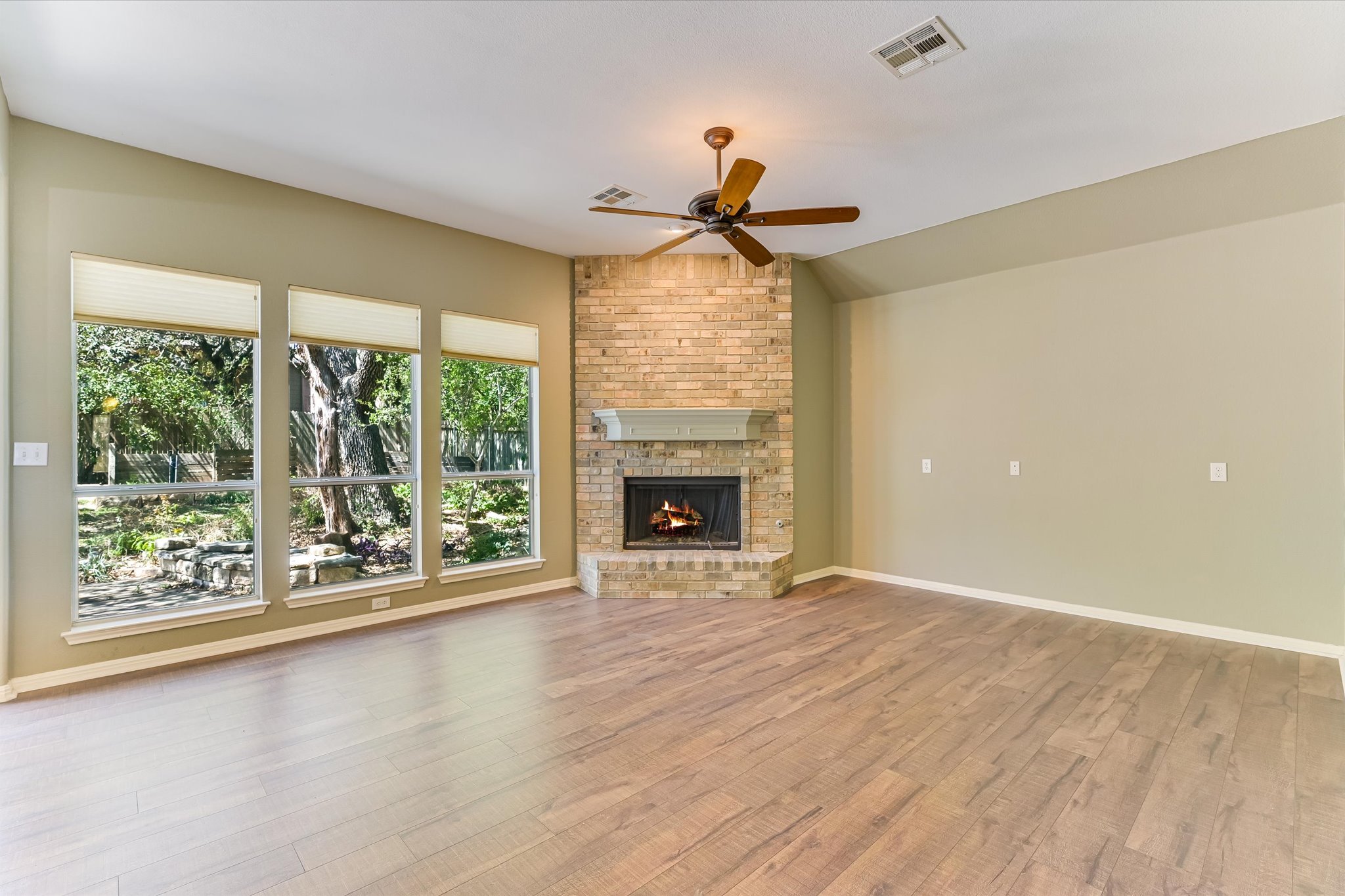 8024 Cobblestone Austin, TX 78735 - Photo 15 of 27 a view of an empty room with wooden floor and a window