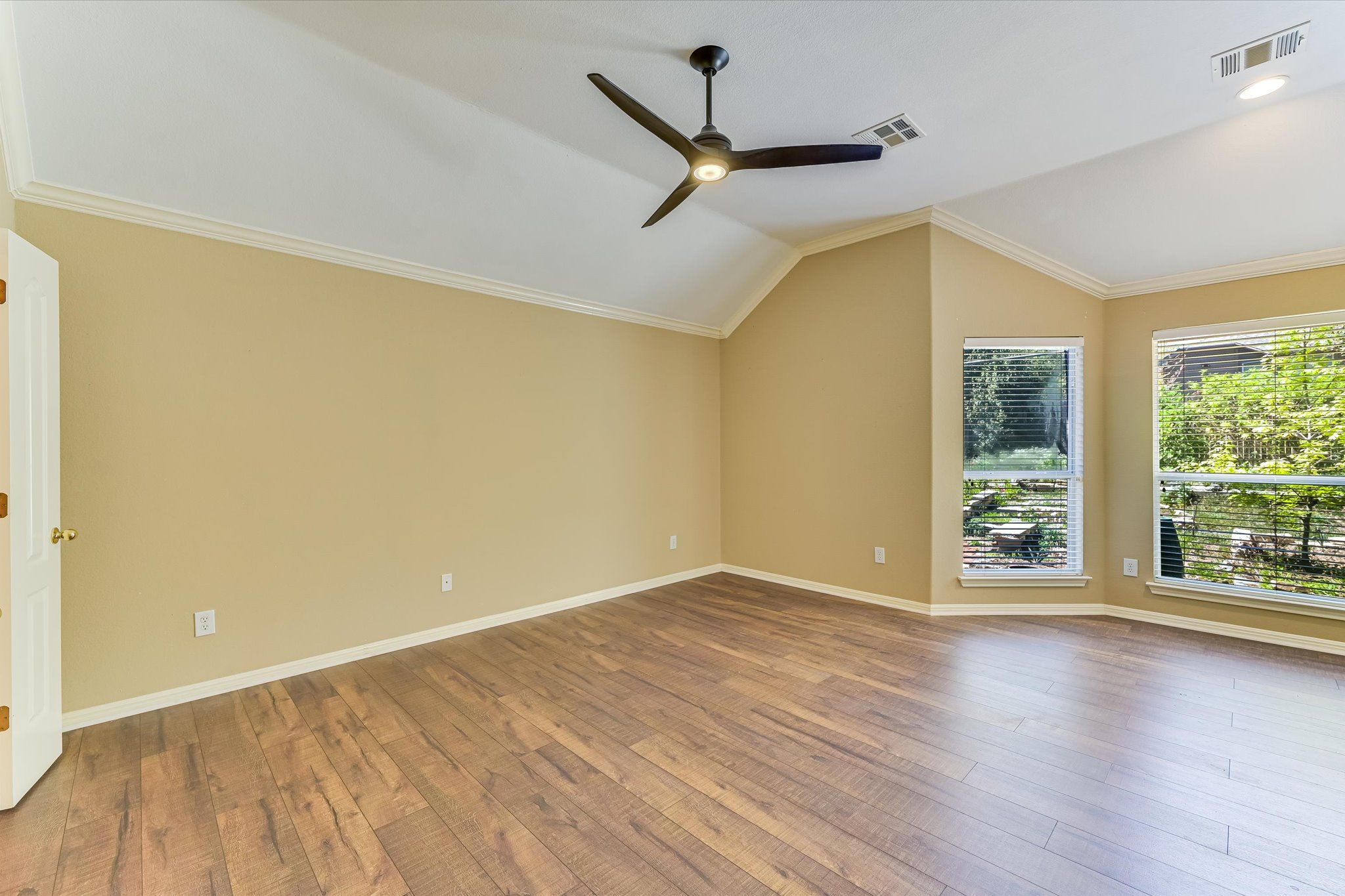 8024 Cobblestone Austin, TX 78735 - Photo 17 of 27 a view of an empty room with wooden floor and a window