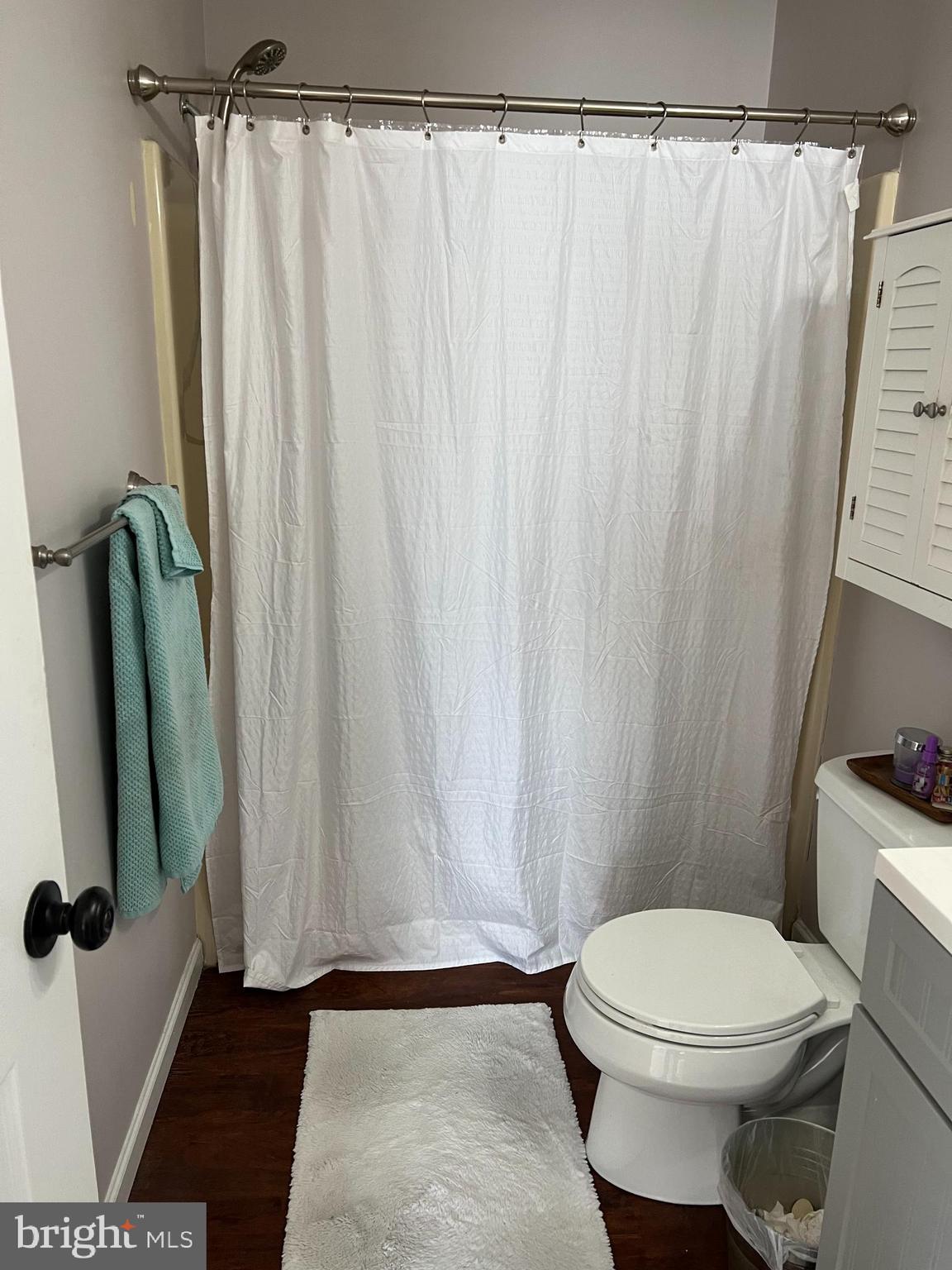 208 Ashley Run Voorhees, NJ 08043 - Photo 13 of 14 a white toilet sitting next to a shower curtain