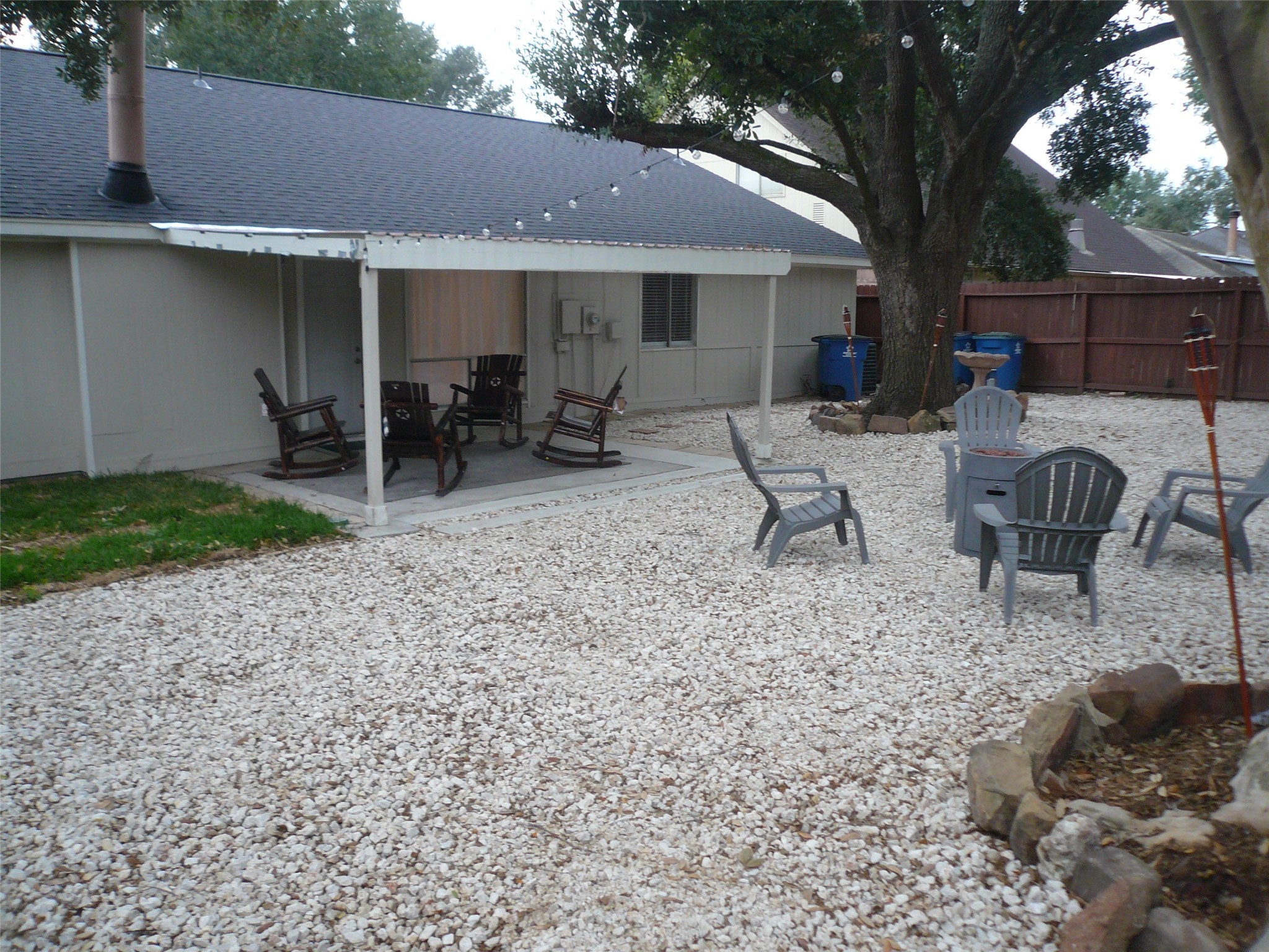 4910 Hennington Drive Spring, TX 77388 - Photo 18 of 18 a view of a backyard with a patio and outdoor seating
