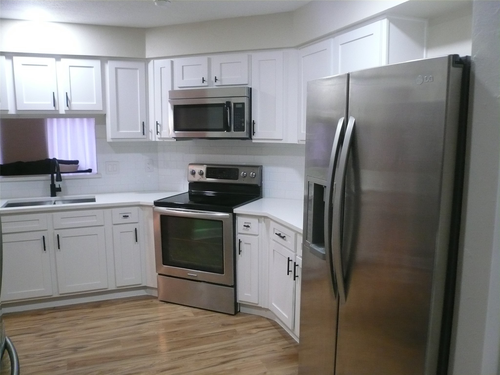 4910 Hennington Drive Spring, TX 77388 - Photo 5 of 18 a kitchen with a refrigerator stove and microwave