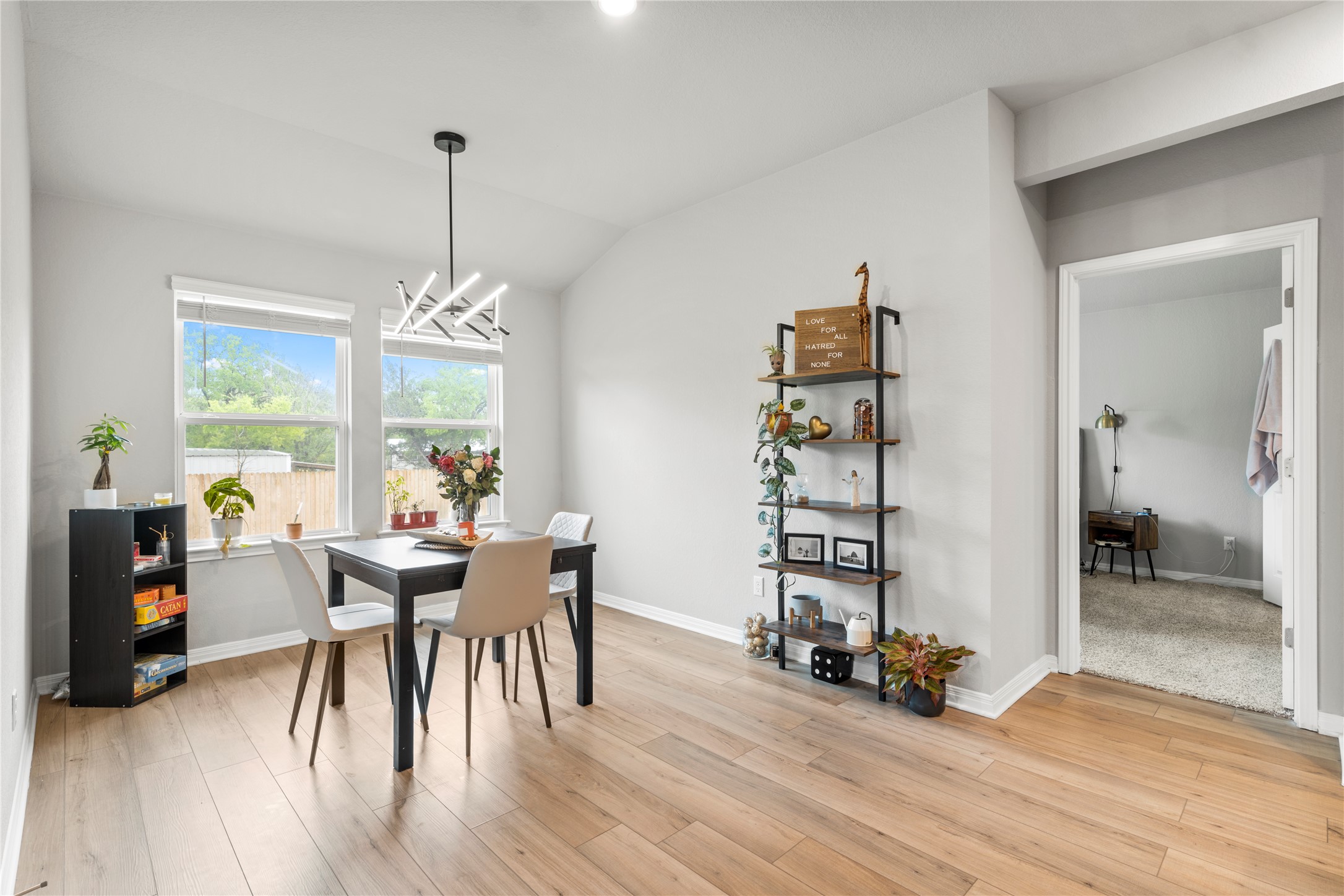11701 Copperstone Avenue Austin, TX 78748 - Photo 11 of 29 Dining area featuring lofted ceiling, a chandelier, and light wood finished floors