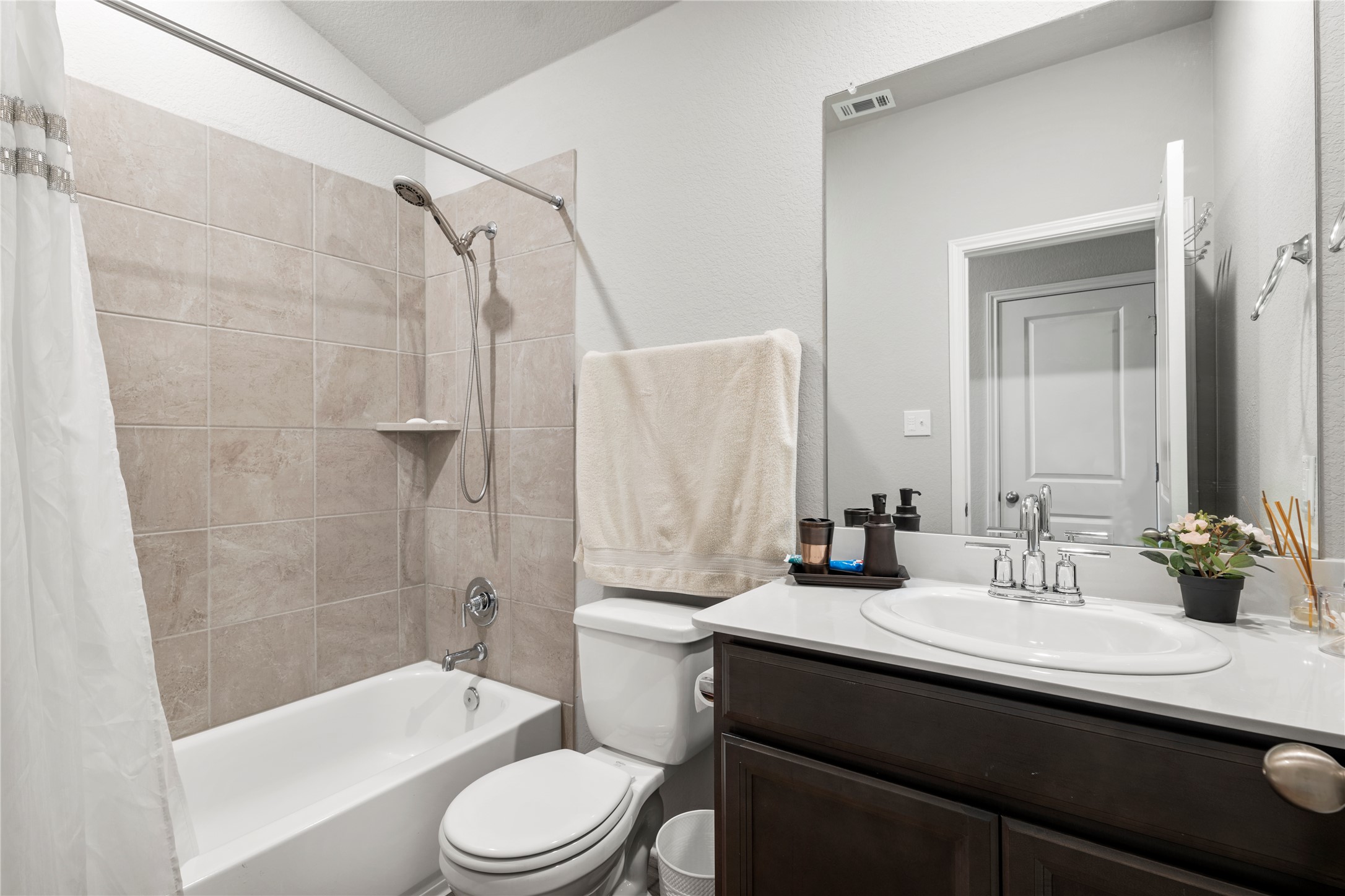 11701 Copperstone Avenue Austin, TX 78748 - Photo 13 of 29 Bathroom with vanity and shower / bath combination with curtain