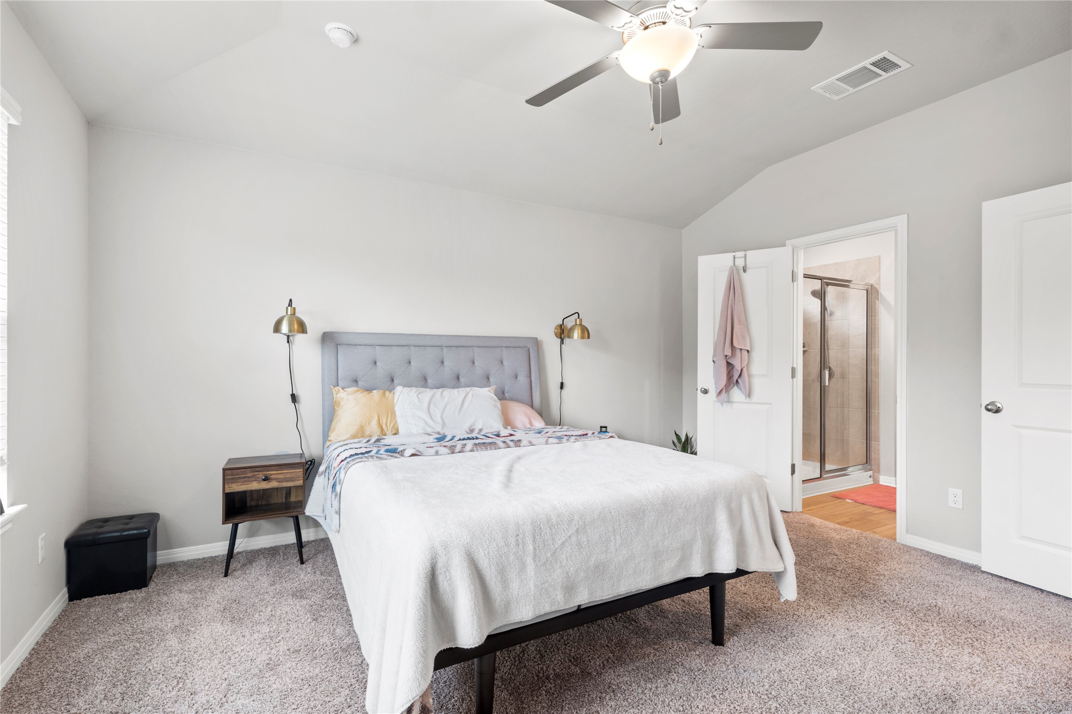 11701 Copperstone Avenue Austin, TX 78748 - Photo 15 of 29 Bedroom featuring vaulted ceiling, light colored carpet, a ceiling fan, and ensuite bathroom