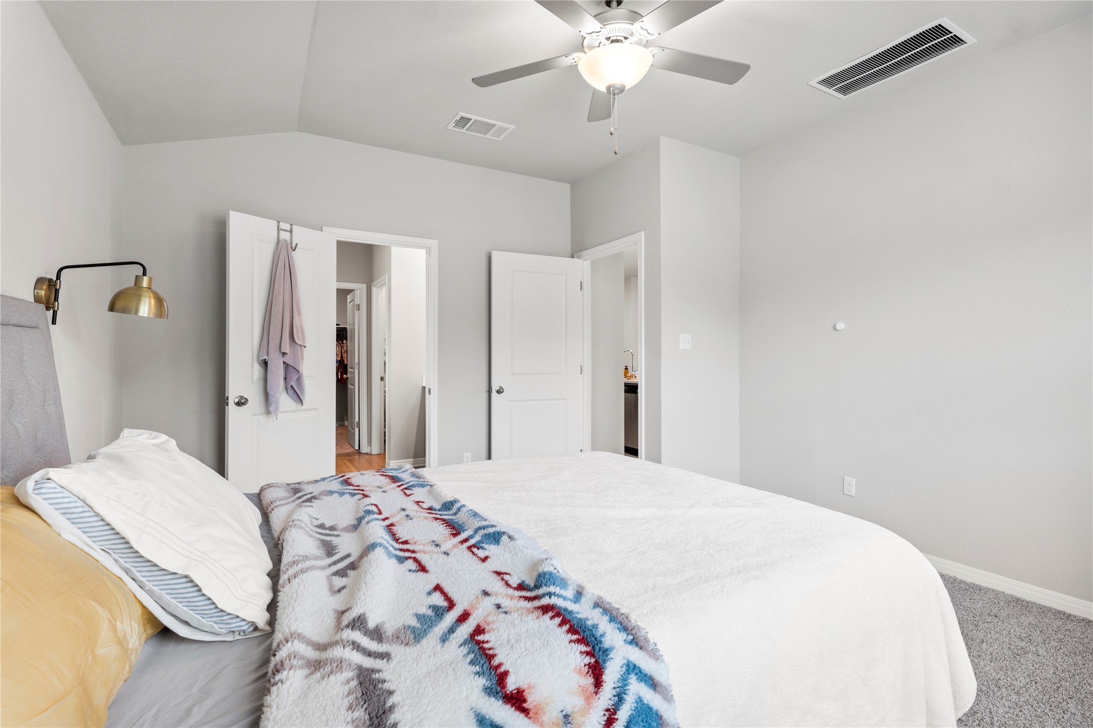 11701 Copperstone Avenue Austin, TX 78748 - Photo 16 of 29 Bedroom featuring light colored carpet, vaulted ceiling, and a ceiling fan