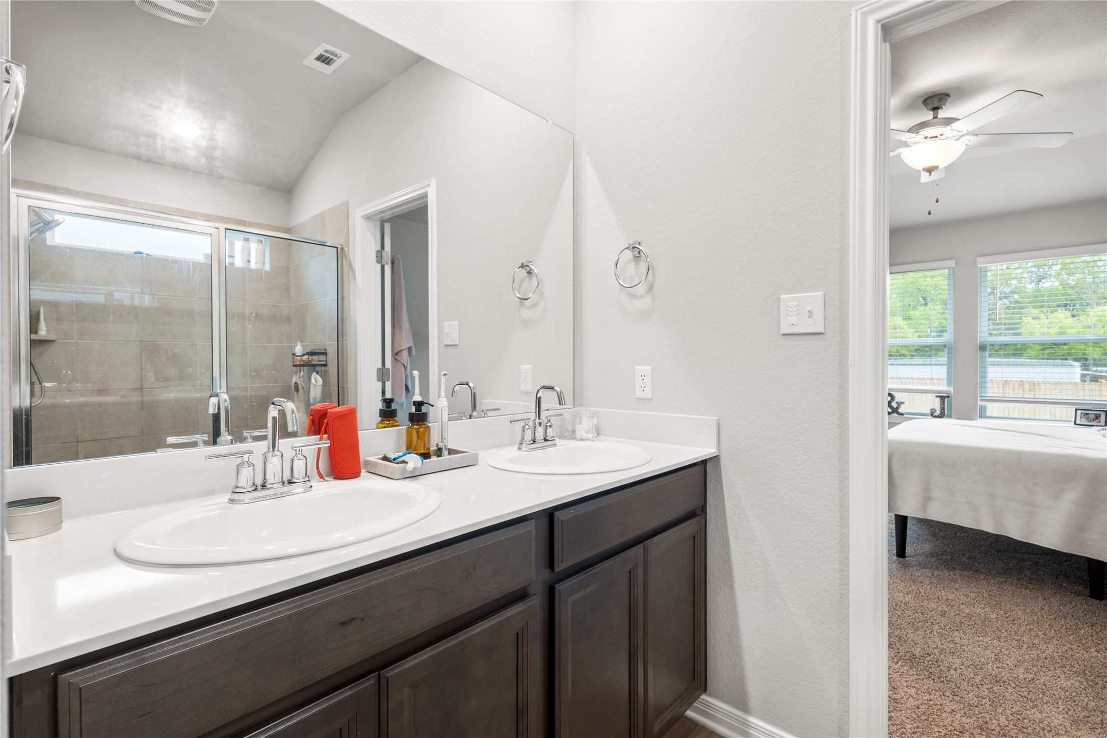 11701 Copperstone Avenue Austin, TX 78748 - Photo 18 of 29 Bathroom with double vanity, healthy amount of natural light, ensuite bathroom, and ceiling fan