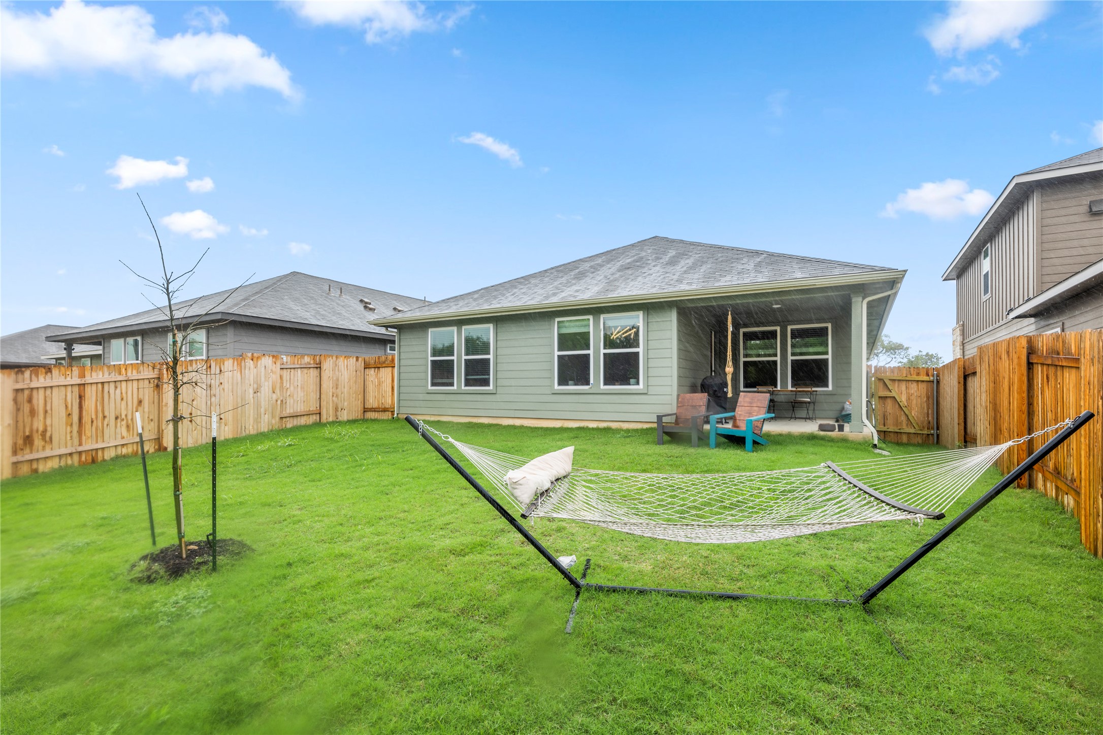 11701 Copperstone Avenue Austin, TX 78748 - Photo 27 of 29 Back of house with a patio area, a fenced backyard, and a gate