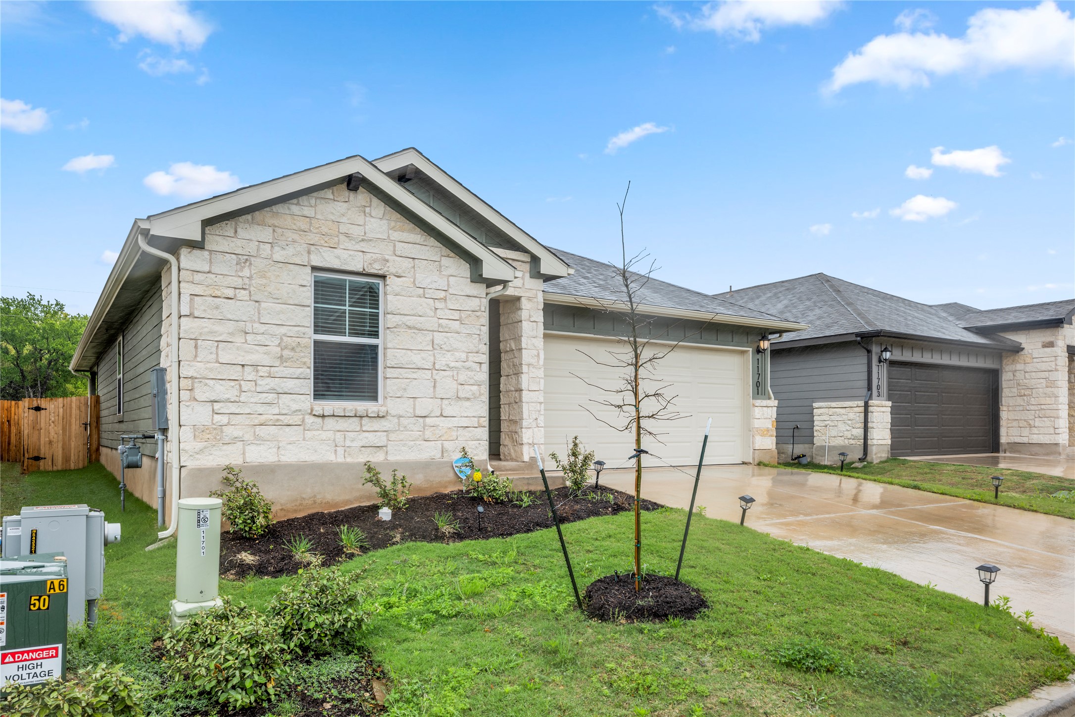 11701 Copperstone Avenue Austin, TX 78748 - Photo 3 of 29 Ranch-style home with an attached garage, stone siding, and concrete driveway