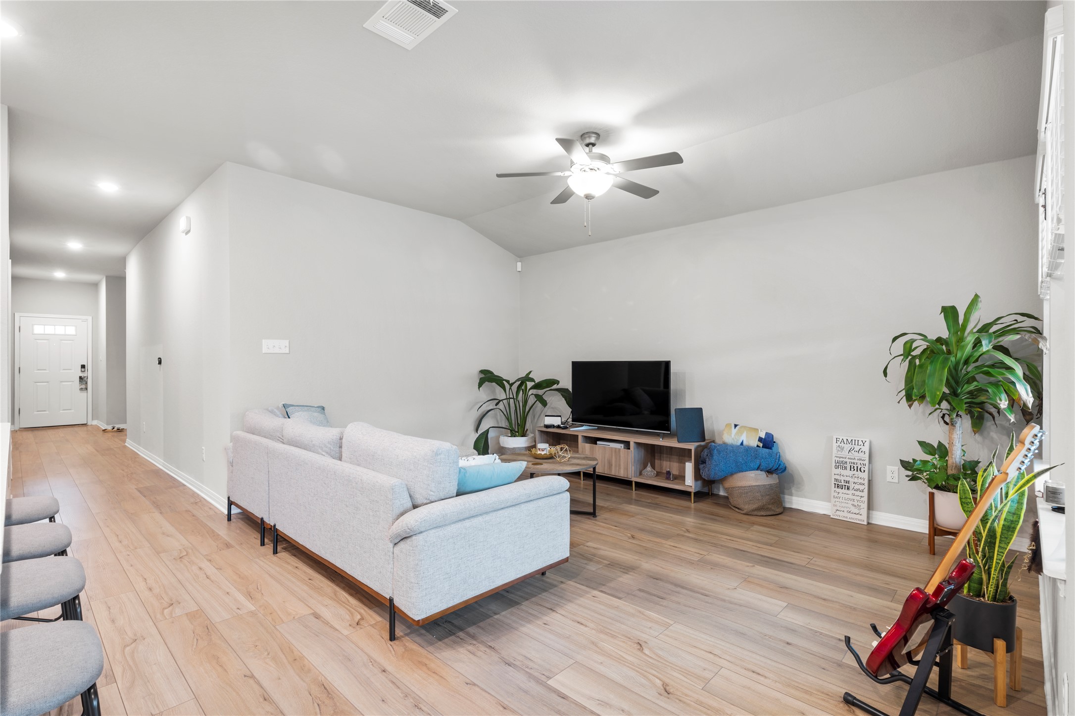 11701 Copperstone Avenue Austin, TX 78748 - Photo 7 of 29 Living room featuring light wood-style flooring, a ceiling fan, vaulted ceiling, and recessed lighting