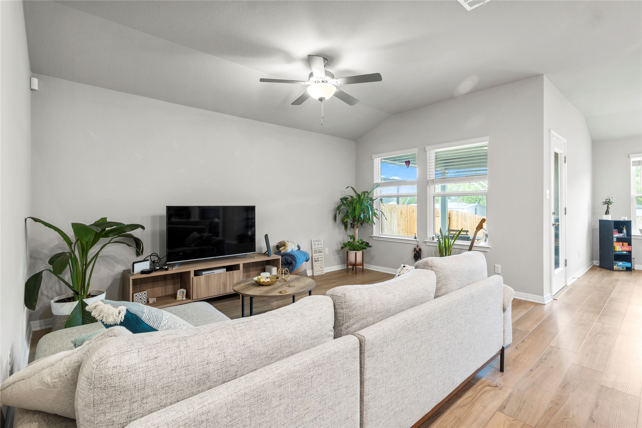 11701 Copperstone Avenue Austin, TX 78748 - Photo 8 of 29 Living room with lofted ceiling, a ceiling fan, and light wood-type flooring