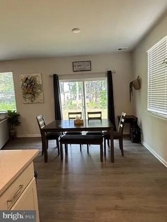 a kitchen with a stove a refrigerator a sink dishwasher with a dining table and chairs