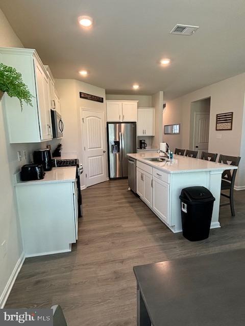 34152 Gooseberry Avenue Ocean View, DE 19970 - Photo 24 of 31 a kitchen with a stove a refrigerator a sink dishwasher with a dining table and chairs