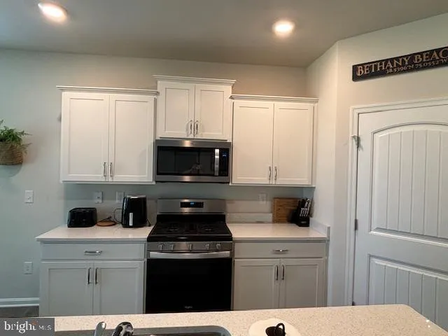 a kitchen with stainless steel appliances a refrigerator and a stove