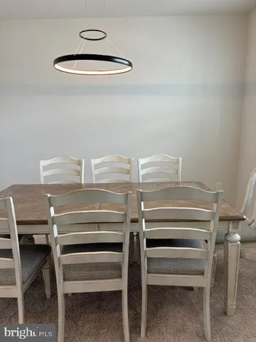 a view of a dining room with a table and chairs