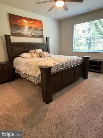 a bedroom with a bed and window